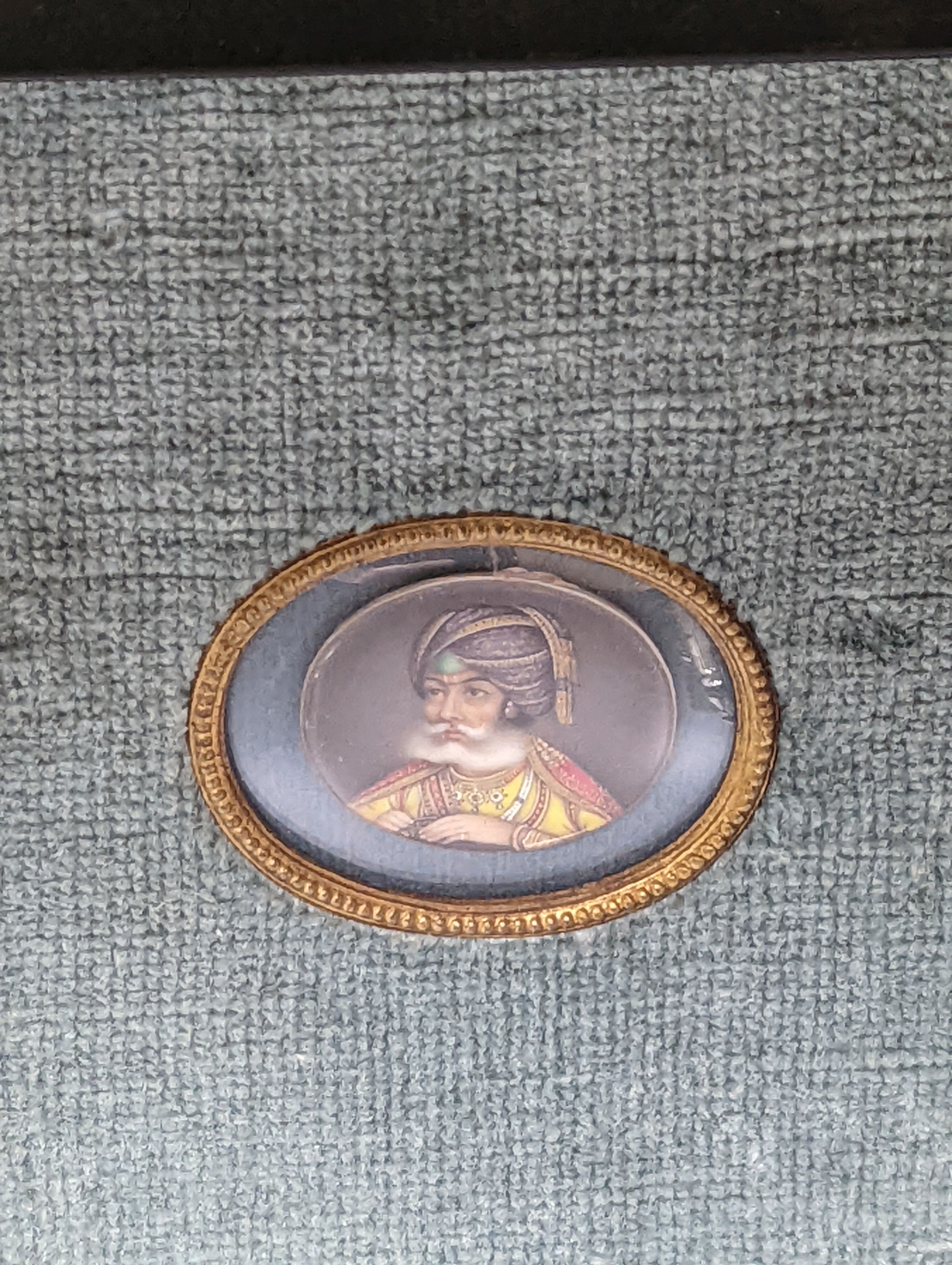 A Moghul miniature on ivory, 3cm. wide, in frame